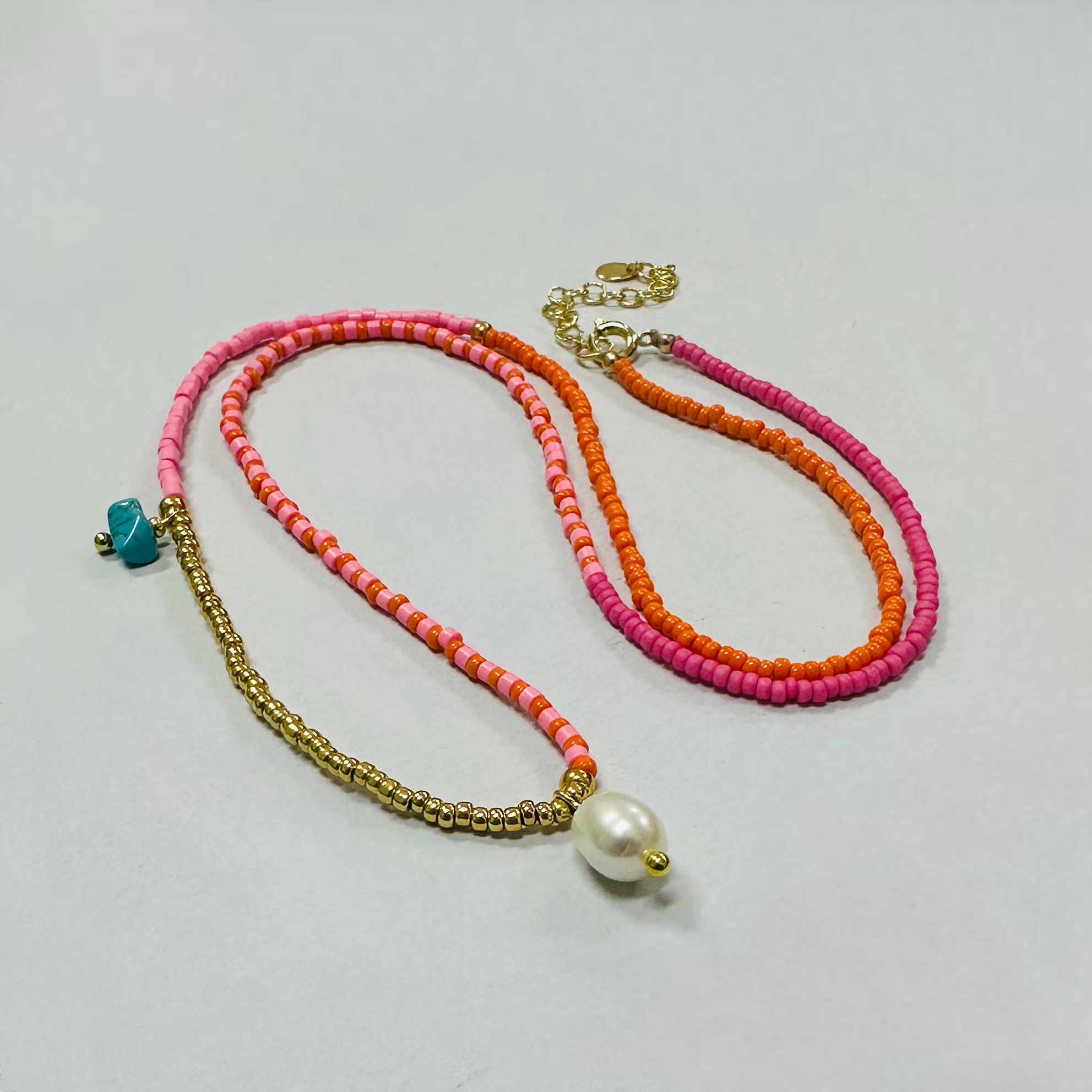 Medium Length Pink and Orange Beaded Necklace with Pearl Pendant
