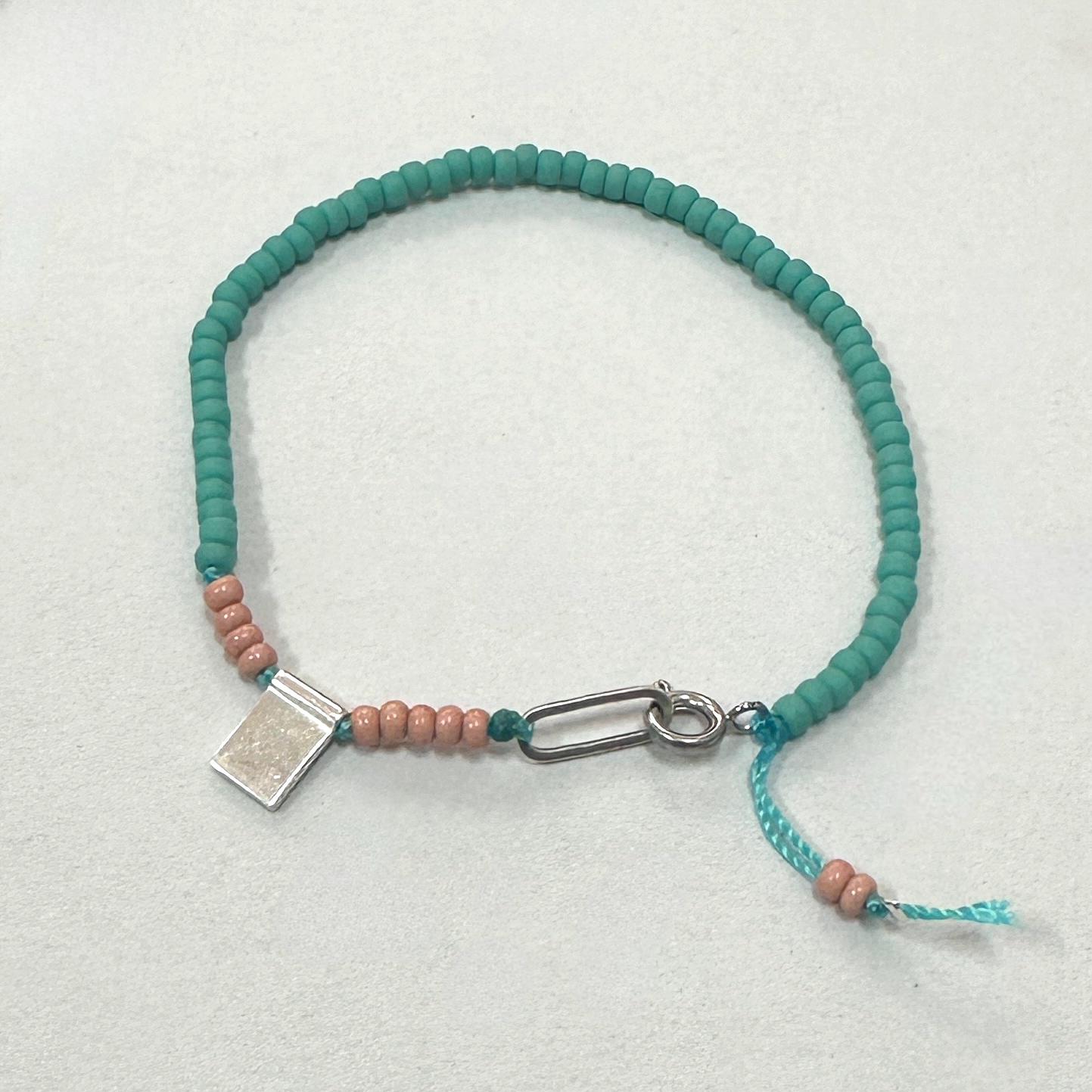 Turquoise and Pink Beaded Bracelet with Silver Tag Charm